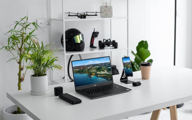 Shopper comparing laptops and electronics before buying during a sale